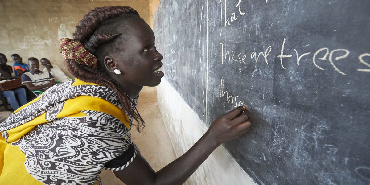 A woman writes on a blackboard in an English class in the JRS Arrupe Learning Center, in Bunj, South Sudan.